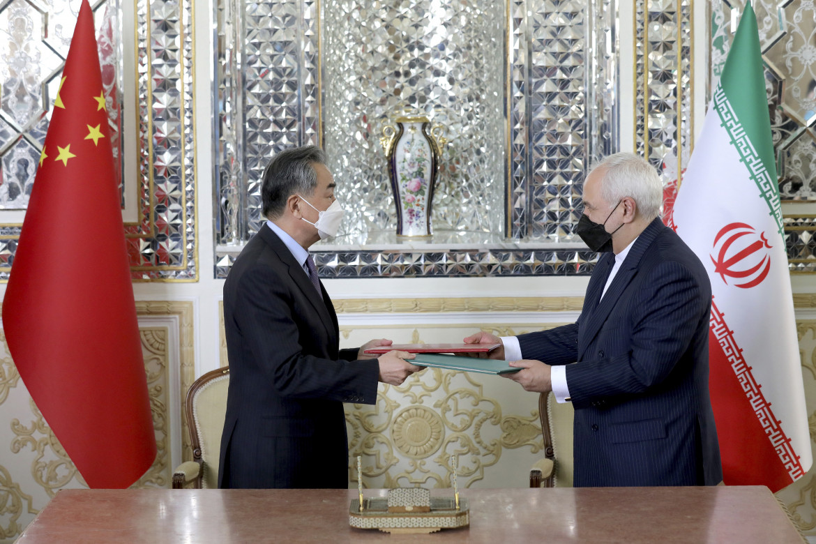 La stretta di mano tra il capo della diplomazia di Tehran, Mohammad Javad Zarif, e il ministro degli esteri cinese, Wang Yi,